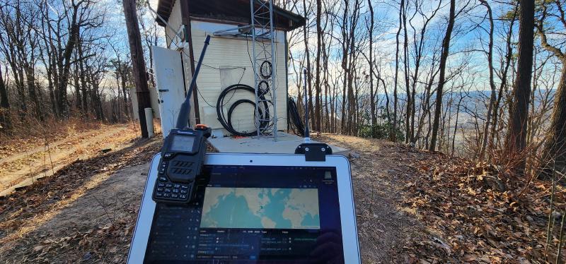 My laptop with a radio and my portable Meshtastic node, looking at Meshsense from my house